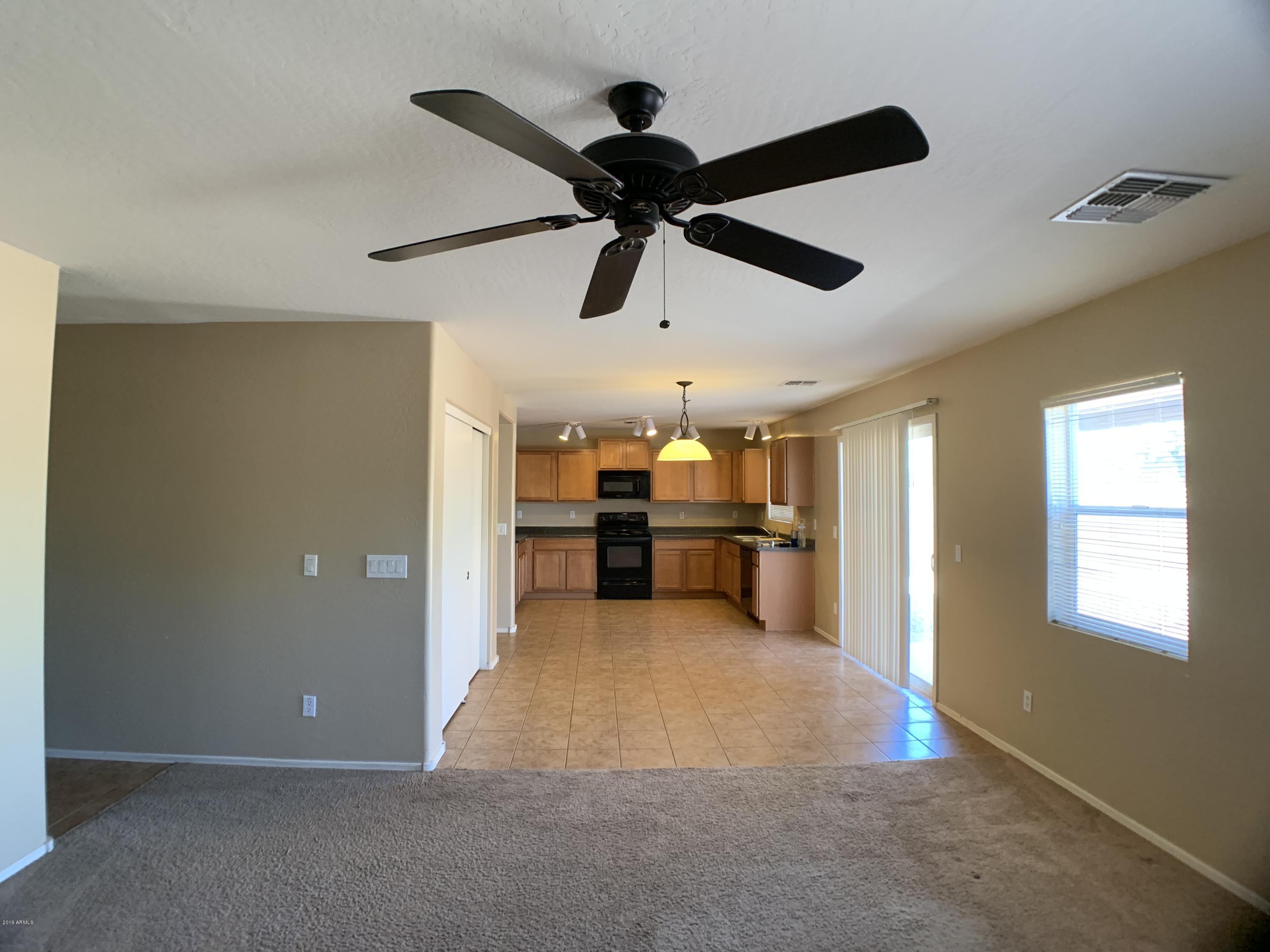 3952 East Morenci Road San Tan Valley, AZ 85143 - Photo 2 of 15 a view of a livingroom with a ceiling fan and window