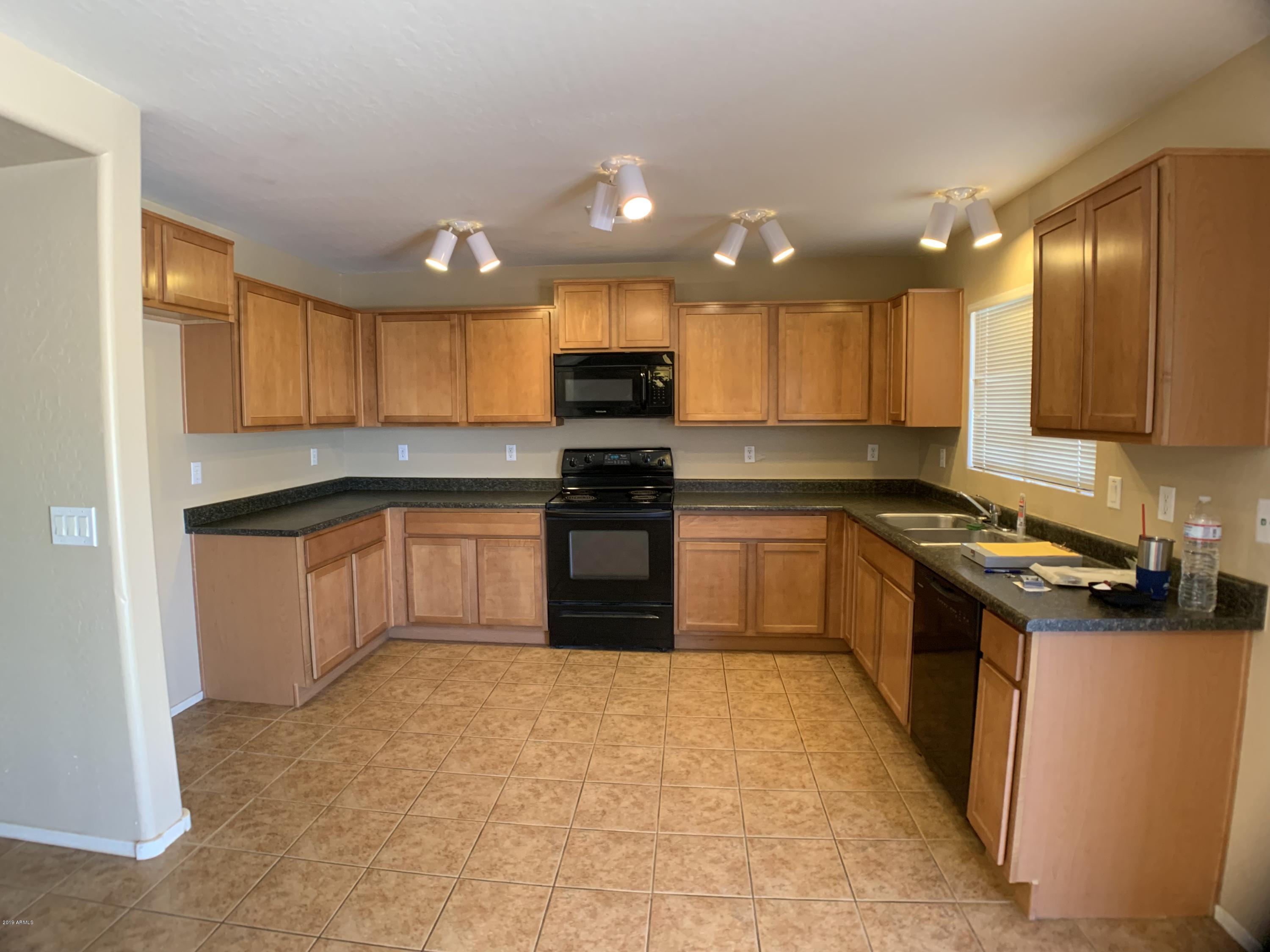 3952 East Morenci Road San Tan Valley, AZ 85143 - Photo 3 of 15 a kitchen with a sink a counter top space stainless steel appliances and cabinets