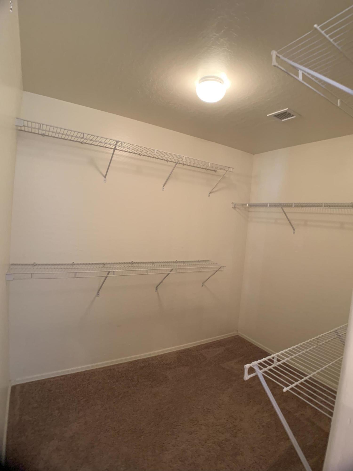 3952 East Morenci Road San Tan Valley, AZ 85143 - Photo 9 of 15 a view of a room with racks on the wall