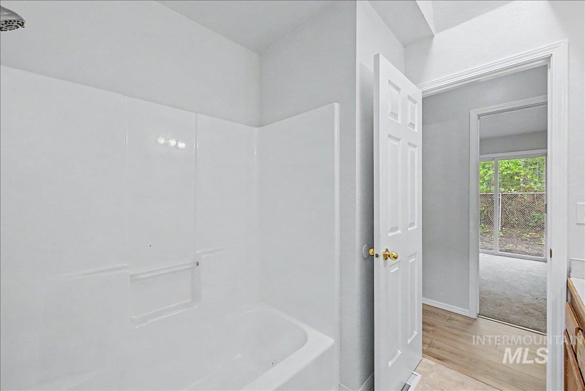 2501 West Hill Road Boise, ID 83702 - Photo 16 of 31 Bathroom with light wood-type flooring, vanity, and shower / bathtub combination
