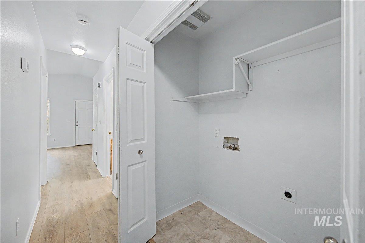 2501 West Hill Road Boise, ID 83702 - Photo 17 of 31 Laundry area featuring washer hookup, light wood-style floors, and electric dryer hookup