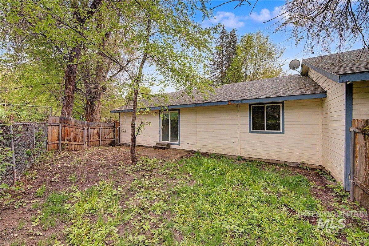2501 West Hill Road Boise, ID 83702 - Photo 29 of 31 Rear view of property with a gate, a fenced backyard, and roof with shingles