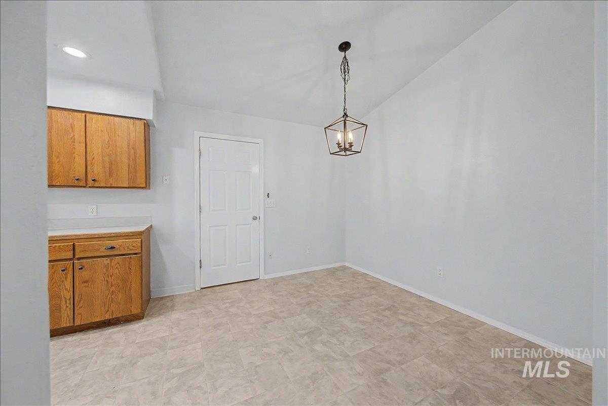 2501 West Hill Road Boise, ID 83702 - Photo 8 of 31 Unfurnished dining area with hanging lights and lofted ceiling