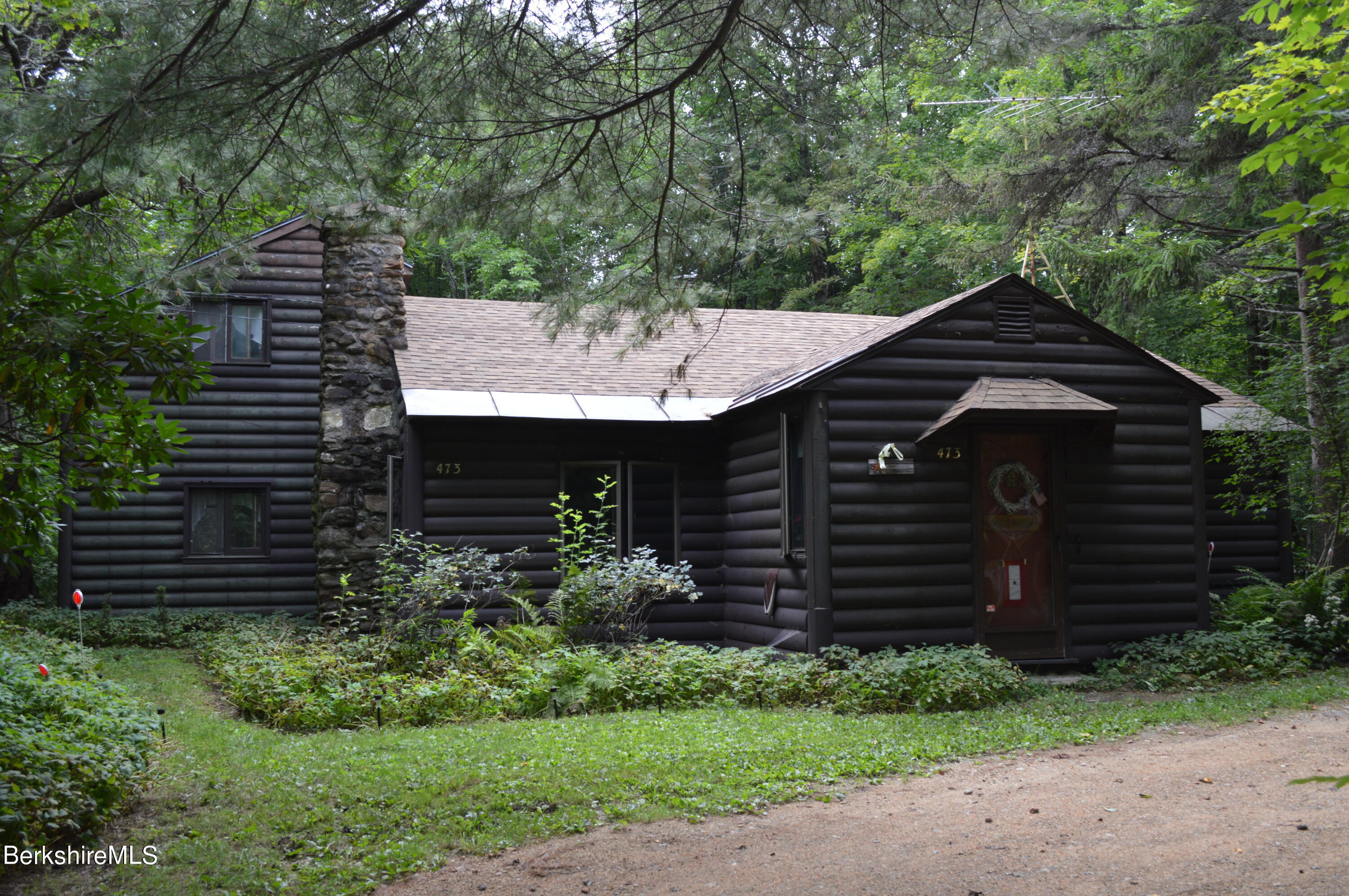 473 County Road Becket, MA 01223 - Photo 1 of 30 a front view of a house with a garden