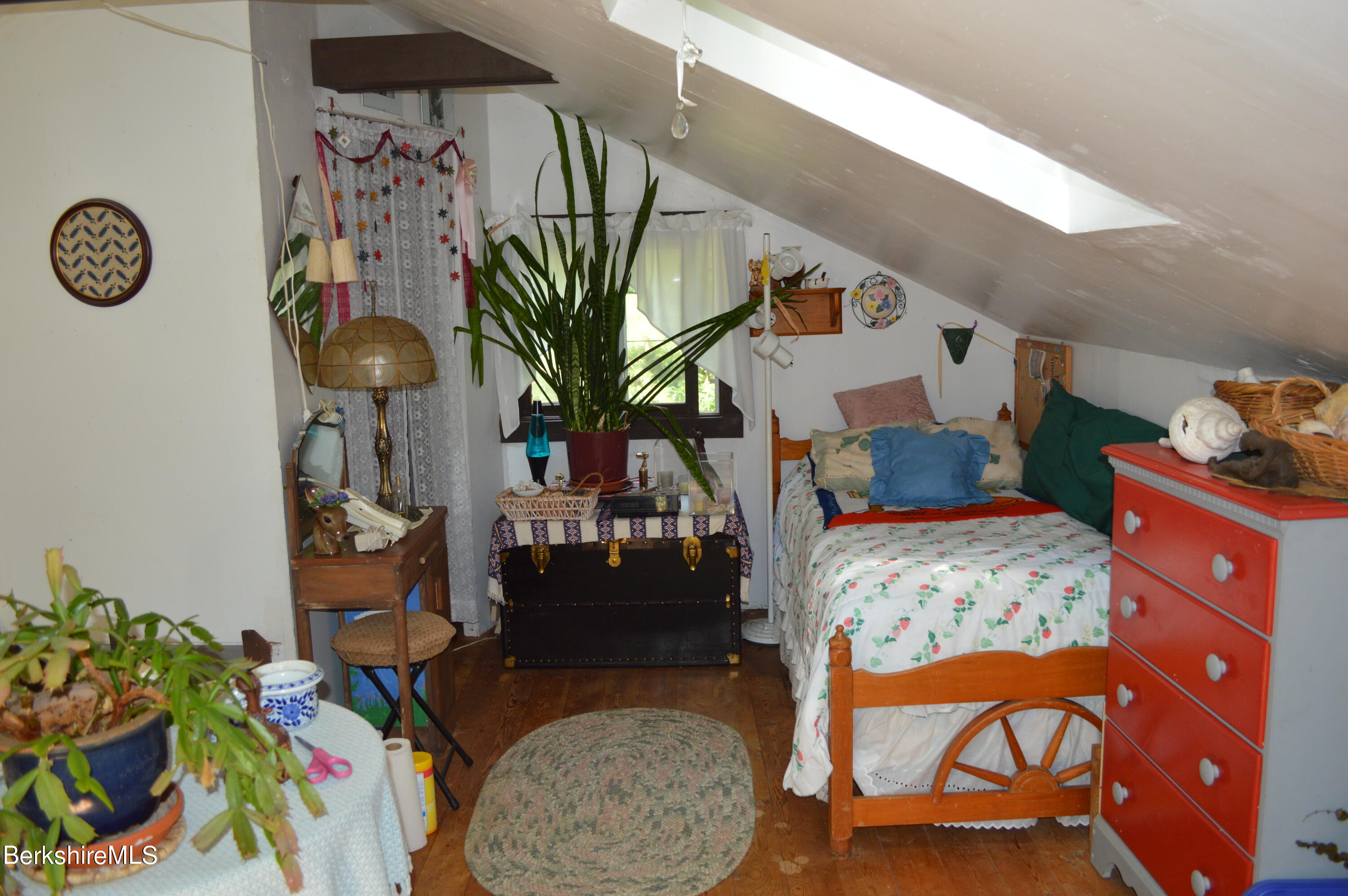 473 County Road Becket, MA 01223 - Photo 15 of 30 a bedroom with a bed and a chandelier