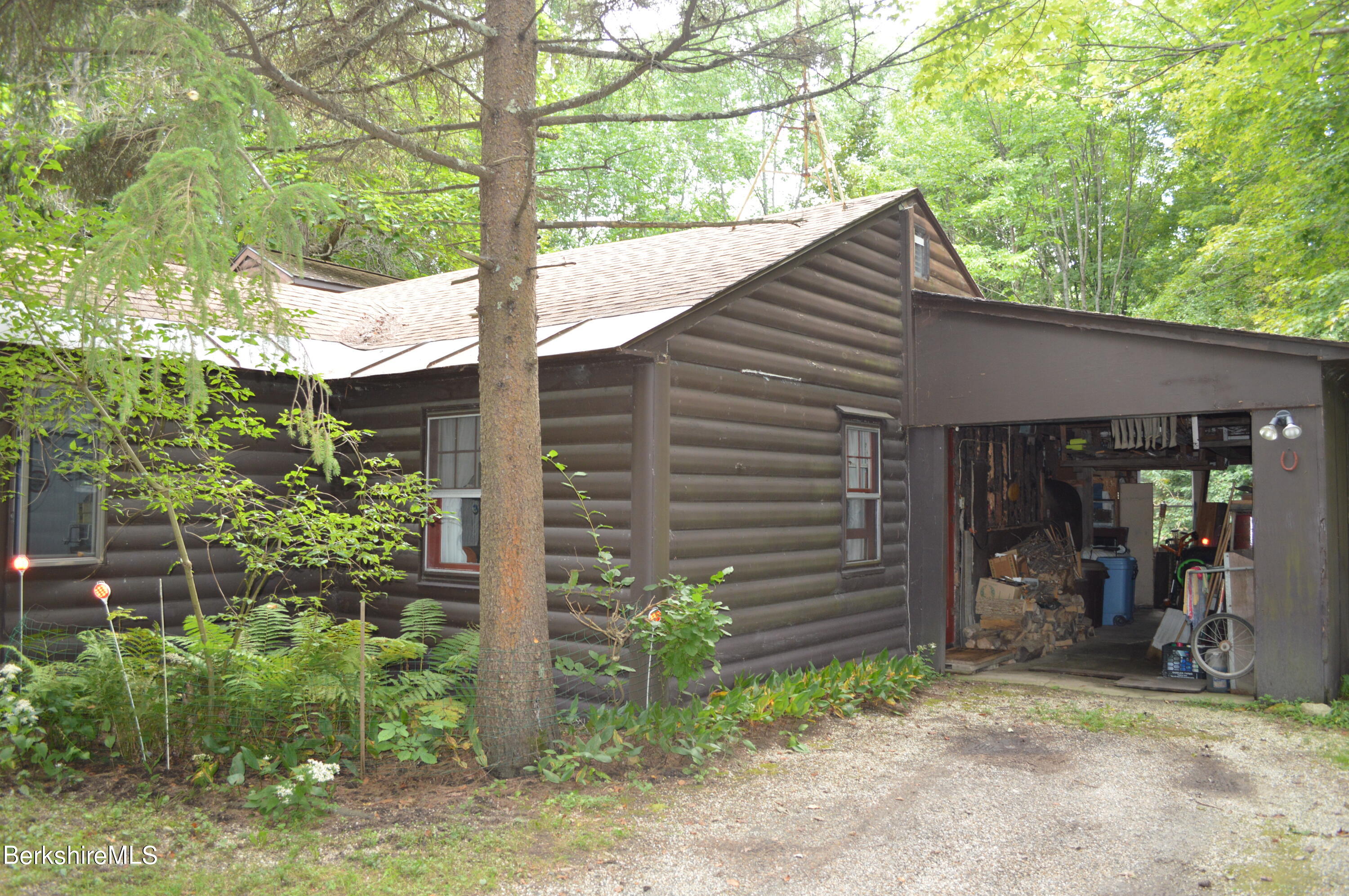473 County Road Becket, MA 01223 - Photo 25 of 30 a backyard of a house with plants and outdoor seating