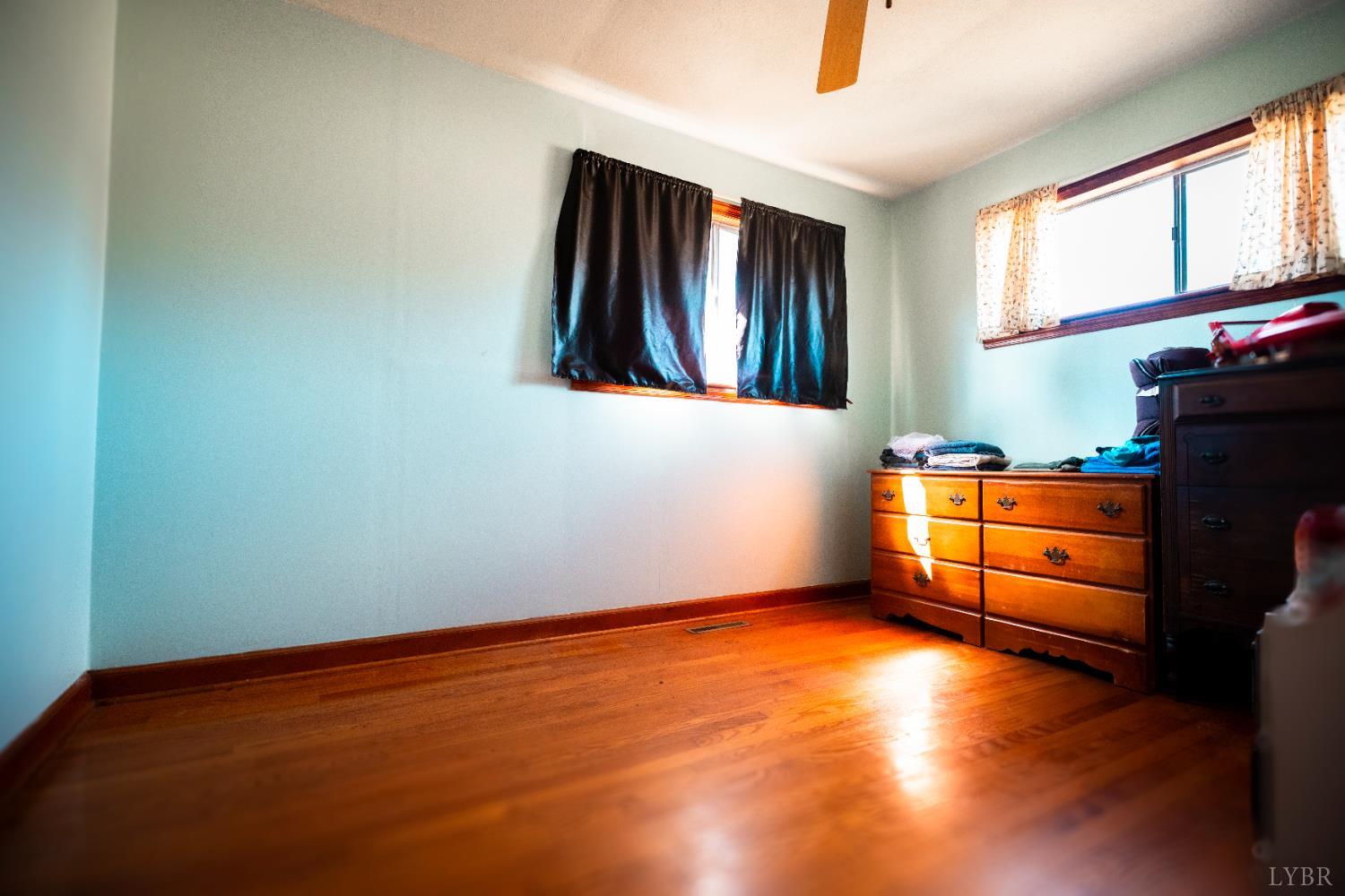 1228 Clover Creek Road Huddleston, VA 24104 - Photo 16 of 25 a view of empty room with wooden floor and fan