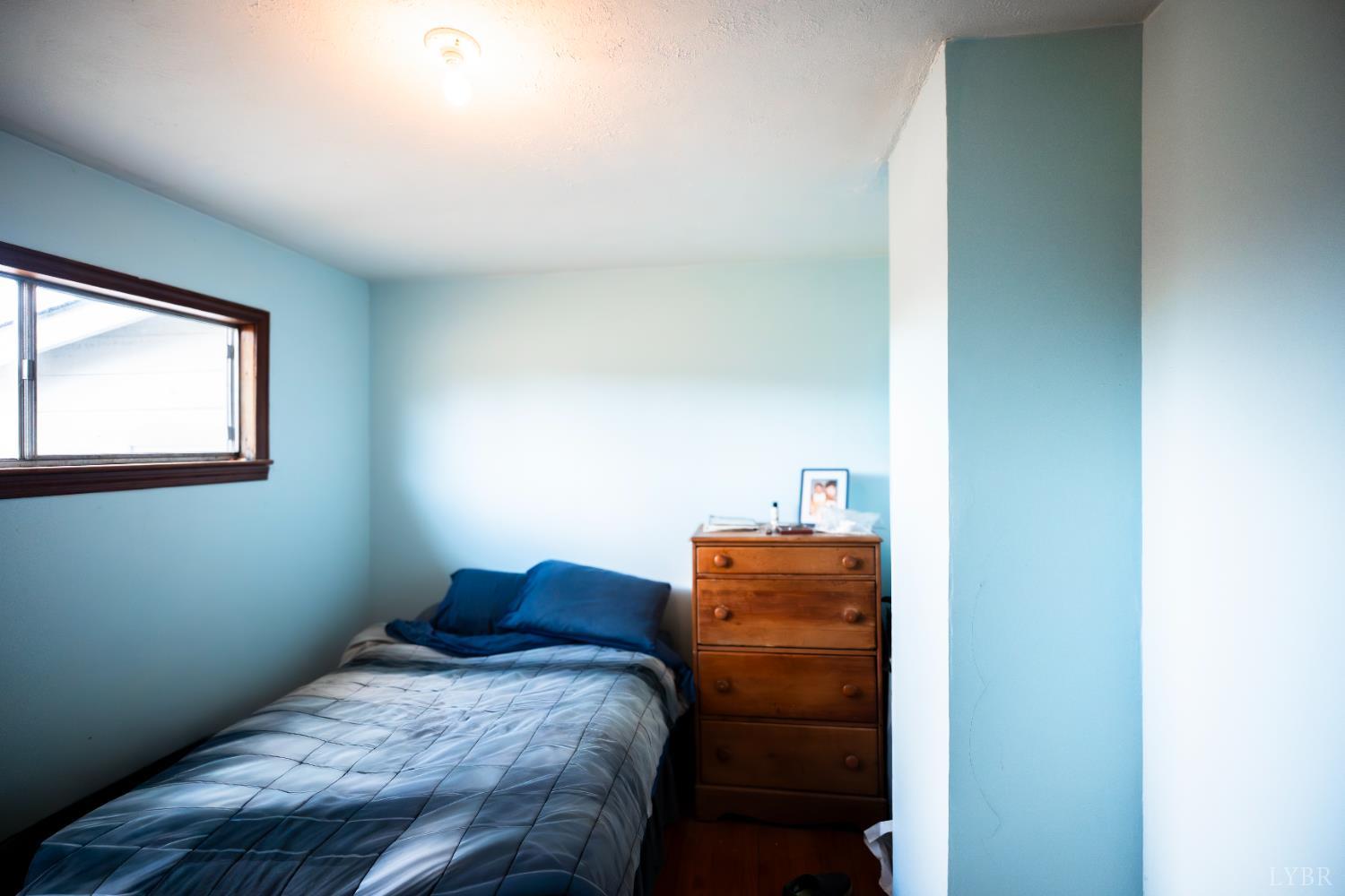 1228 Clover Creek Road Huddleston, VA 24104 - Photo 21 of 25 a bedroom with a bed and a window