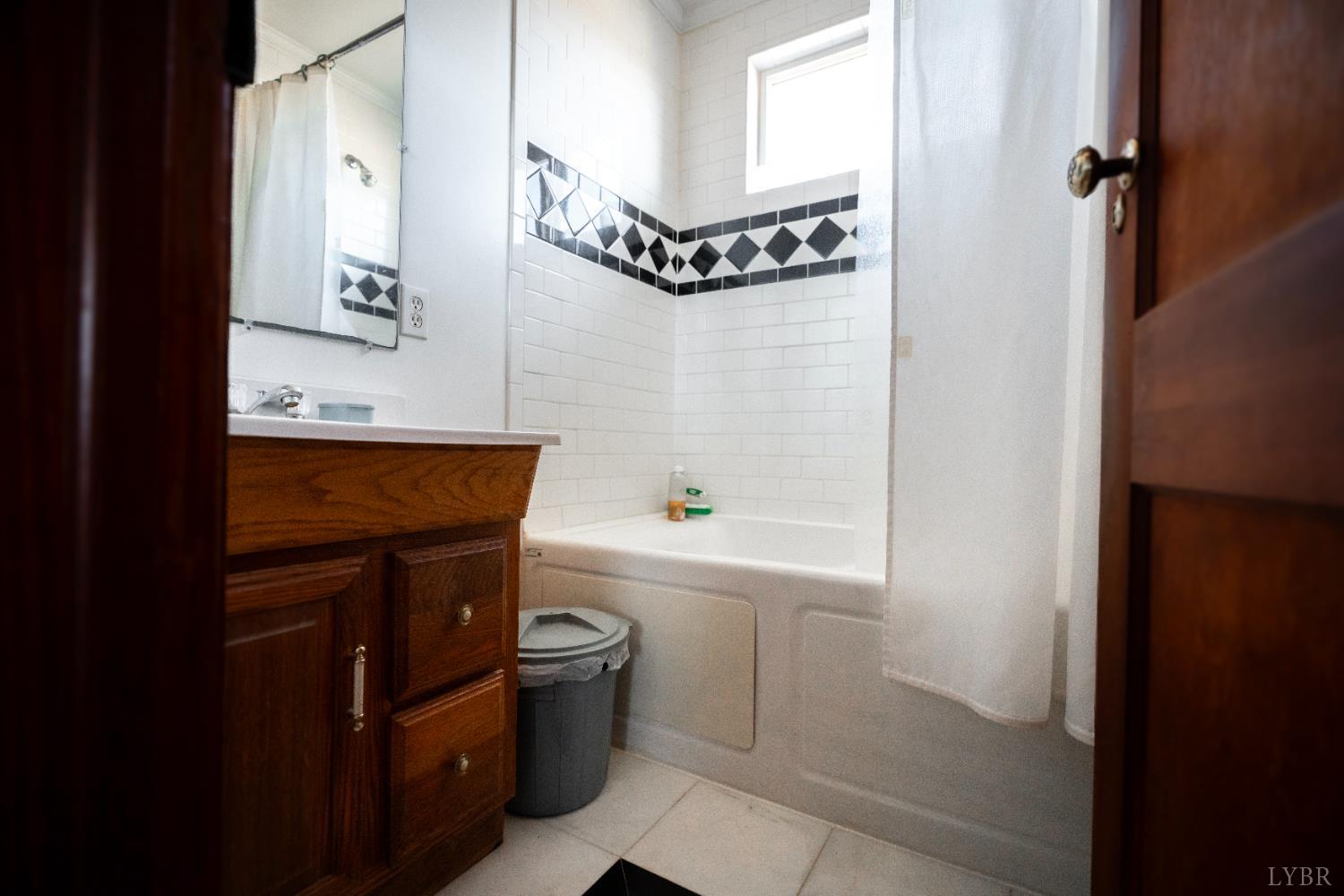 1228 Clover Creek Road Huddleston, VA 24104 - Photo 21 of 25 a bathroom with a bathtub a sink and a window