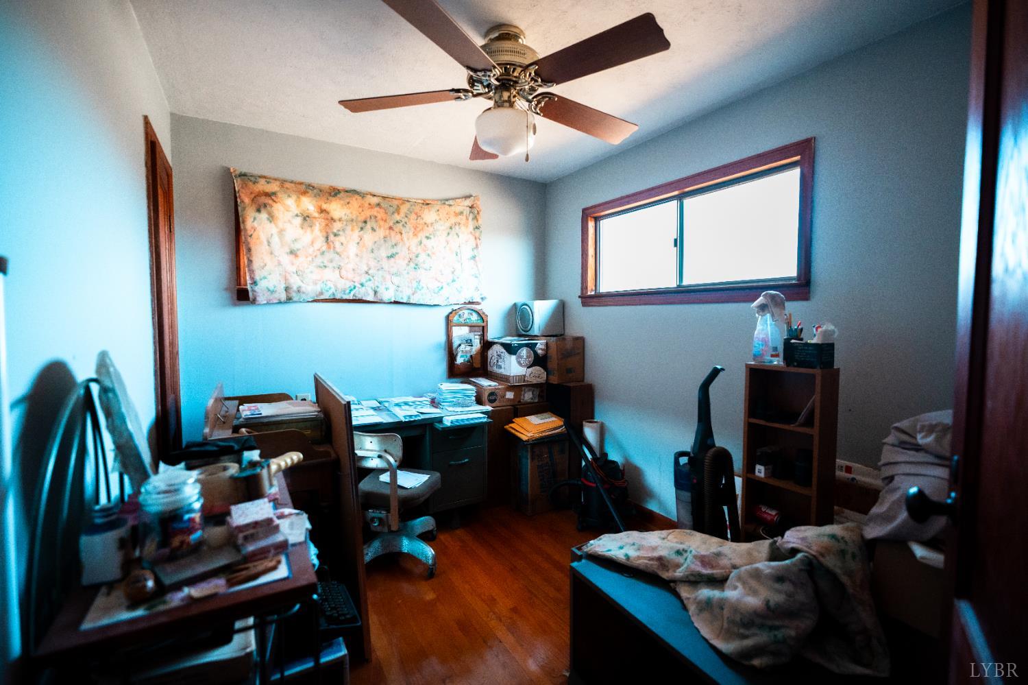 1228 Clover Creek Road Huddleston, VA 24104 - Photo 6 of 25 a work room with furniture and wooden floor