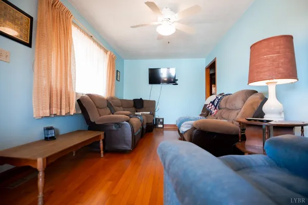 a living room with furniture a window and a flat screen tv