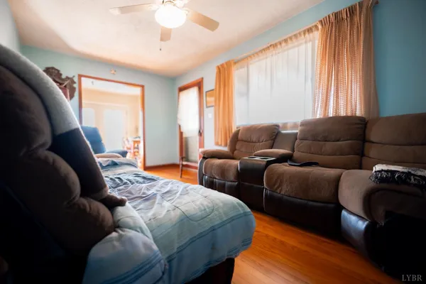a bedroom with furniture and a large window