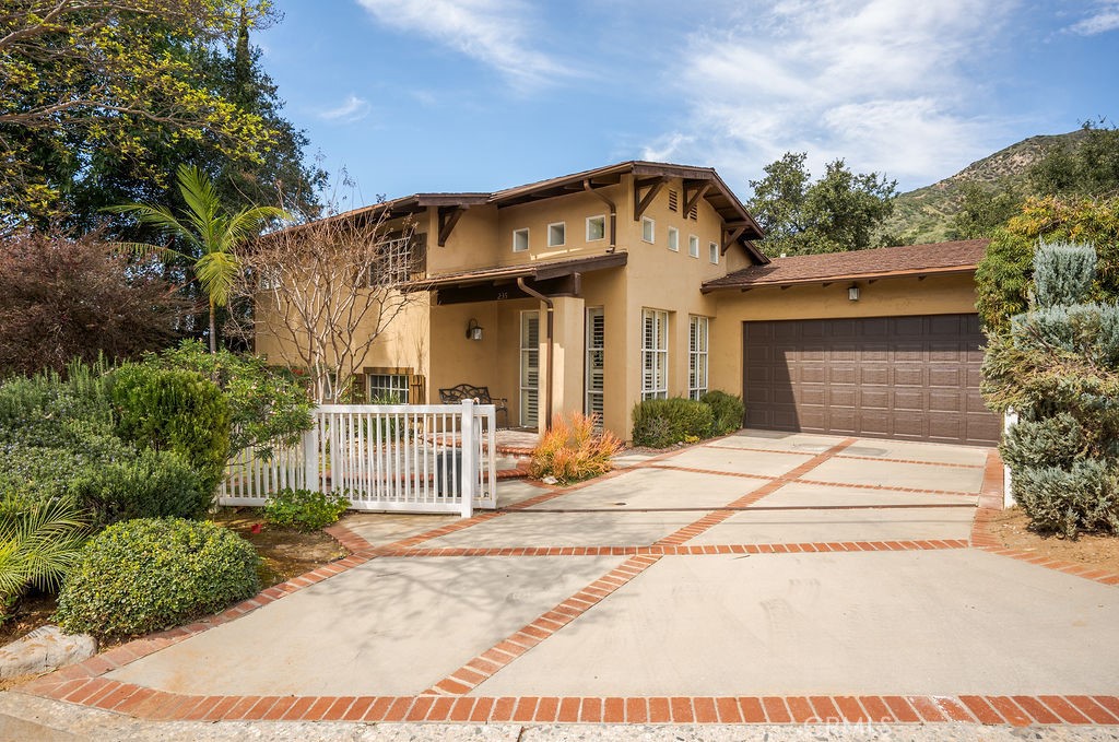 235 Spinks Canyon Road Duarte, CA 91010 - Photo 50 of 50 a front view of a house with a garden and garage