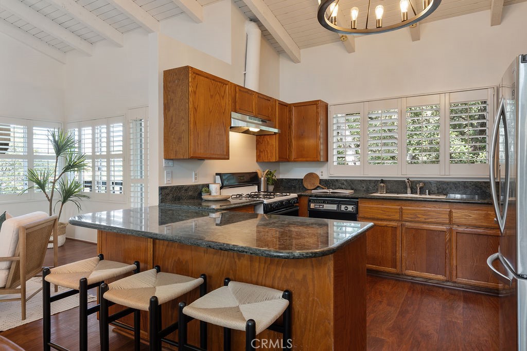 235 Spinks Canyon Road Duarte, CA 91010 - Photo 9 of 50 a kitchen with a table chairs sink and cabinets