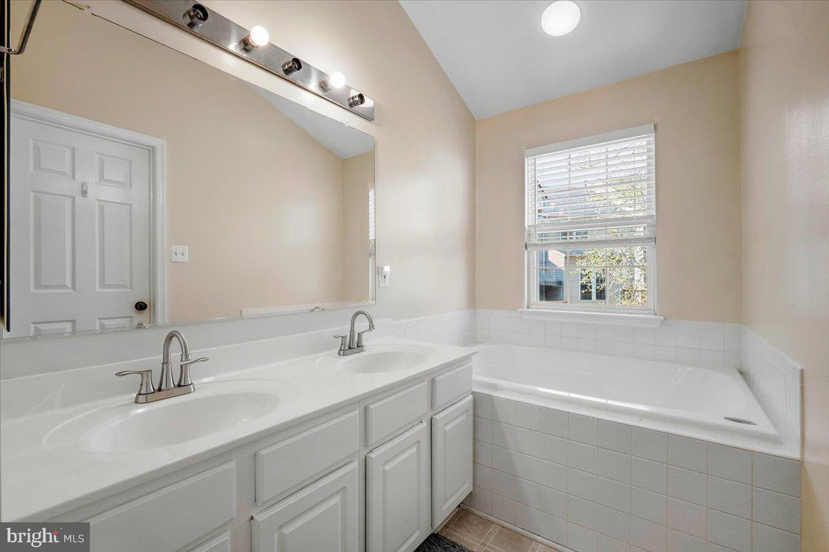 22019 Box Car Square Sterling, VA 20166 - Photo 16 of 31 a bathroom with a double vanity sink and a bathtub
