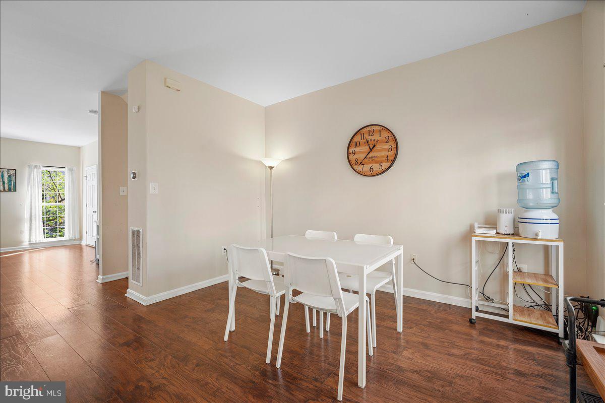 22019 Box Car Square Sterling, VA 20166 - Photo 6 of 31 a view of a dining room with wooden floor a table and chairs