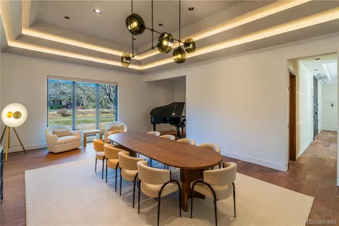 a living room with furniture a rug and a large window