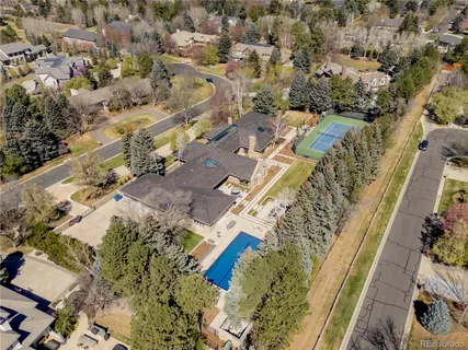 a living room with furniture a flat screen tv and a floor to ceiling window