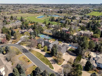 a large kitchen with kitchen island granite countertop a sink a counter and chairs