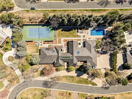 a living room with a large window and furniture