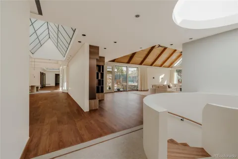 a large white kitchen with a large window