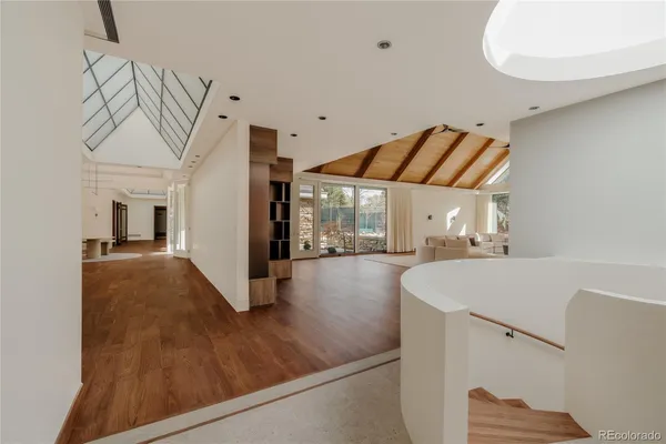 a large white kitchen with a large window