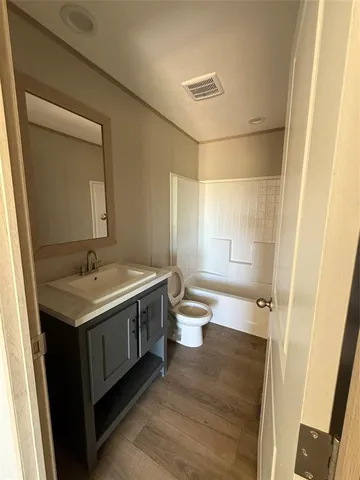 a bathroom with a granite countertop sink a toilet and a mirror