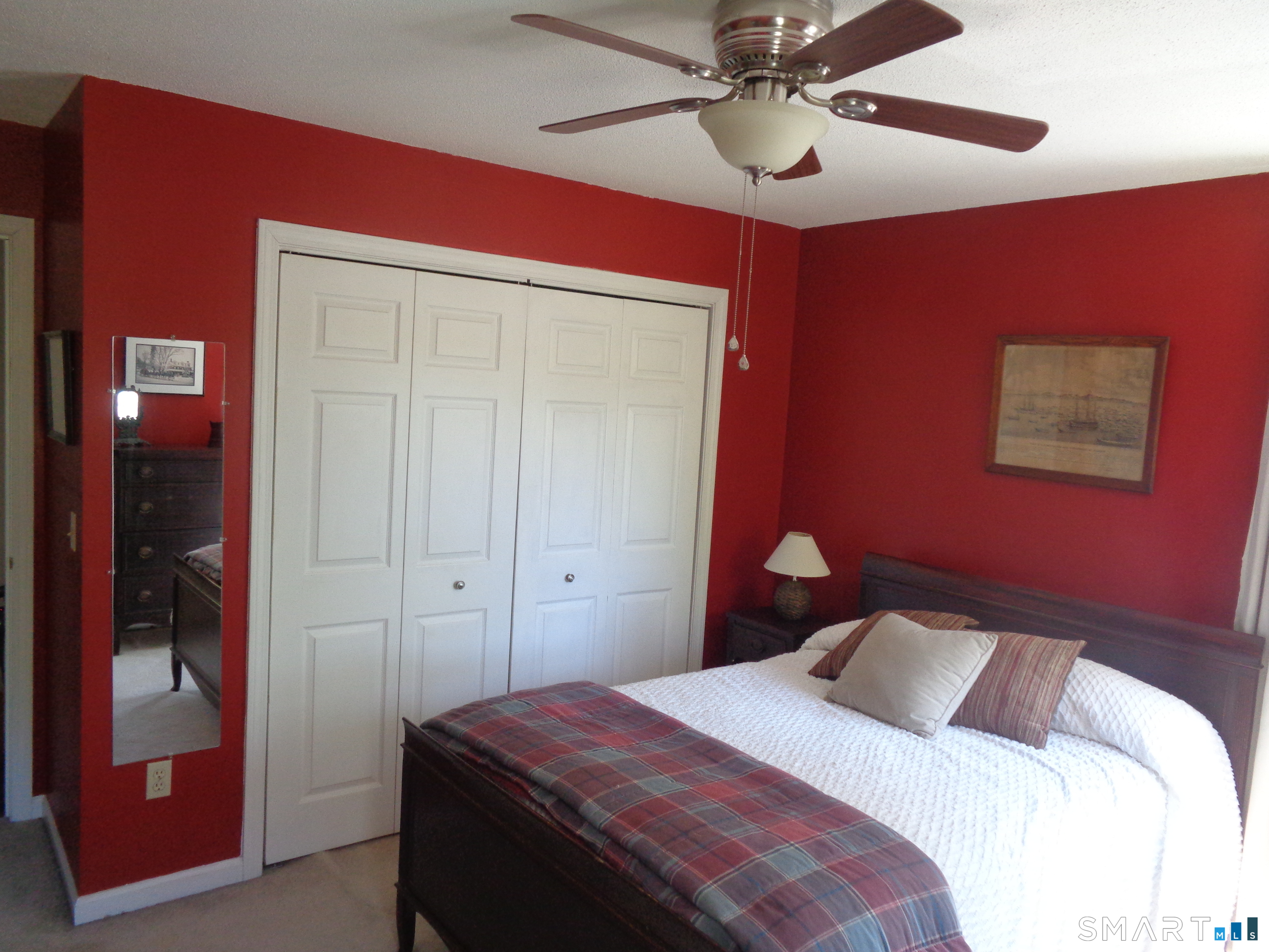 321 Spring Street Naugatuck, CT 06770 - Photo 10 of 27 a bedroom with a bed and a chandelier