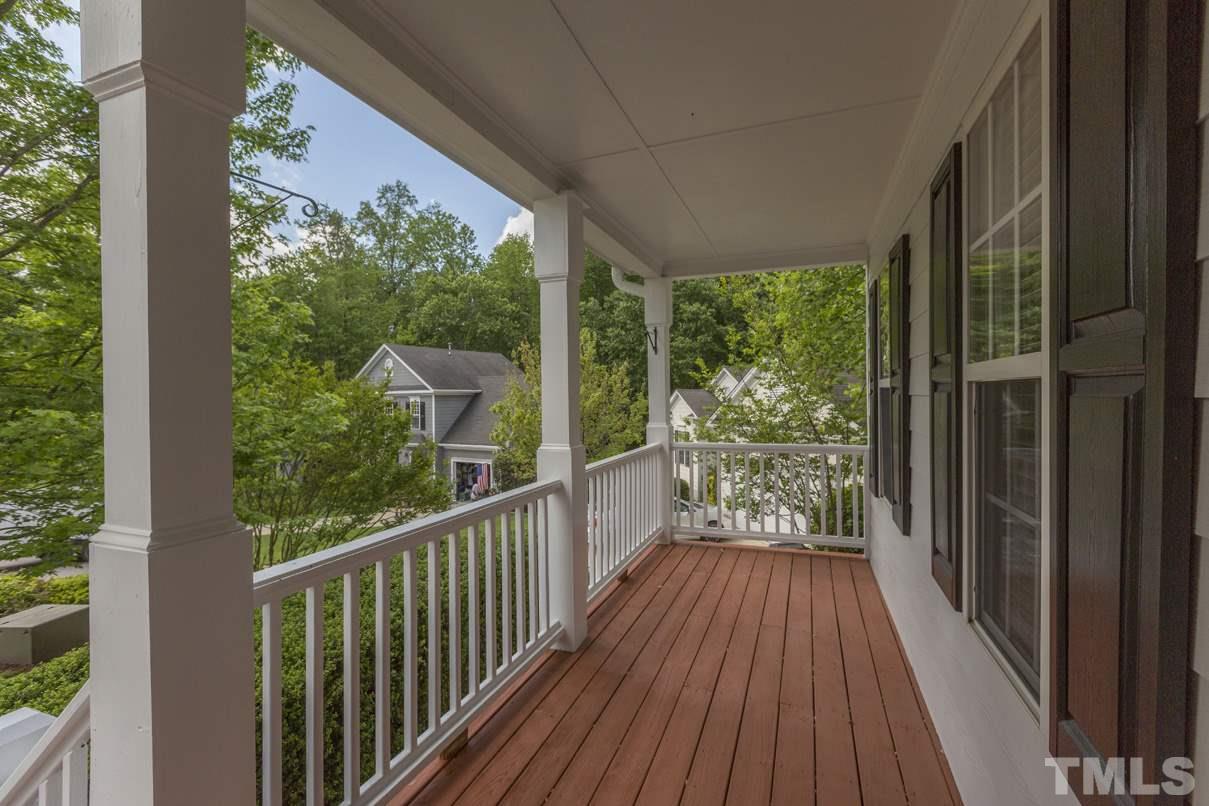 826 Shackleton Road Apex, NC 27502 - Photo 2 of 24 a view of a room with wooden floor and iron stairs