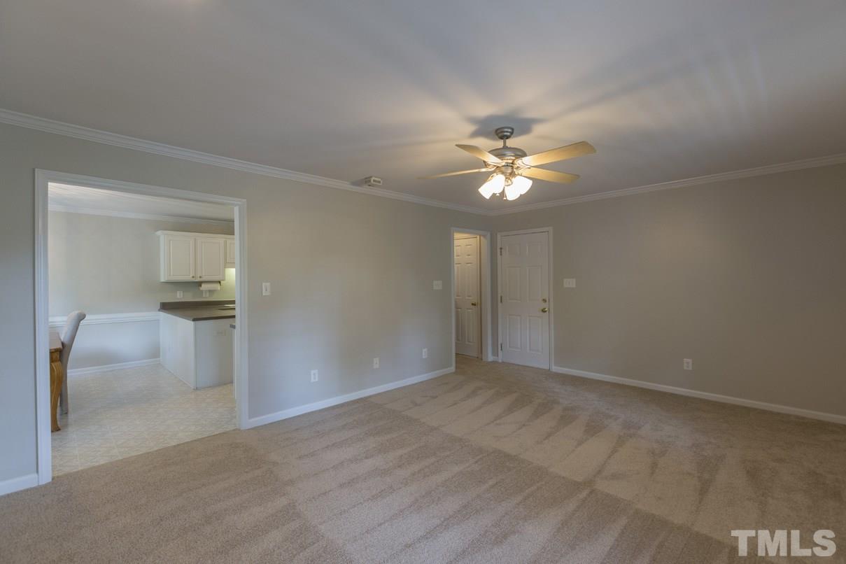 826 Shackleton Road Apex, NC 27502 - Photo 15 of 24 a view of an empty room with a ceiling fan