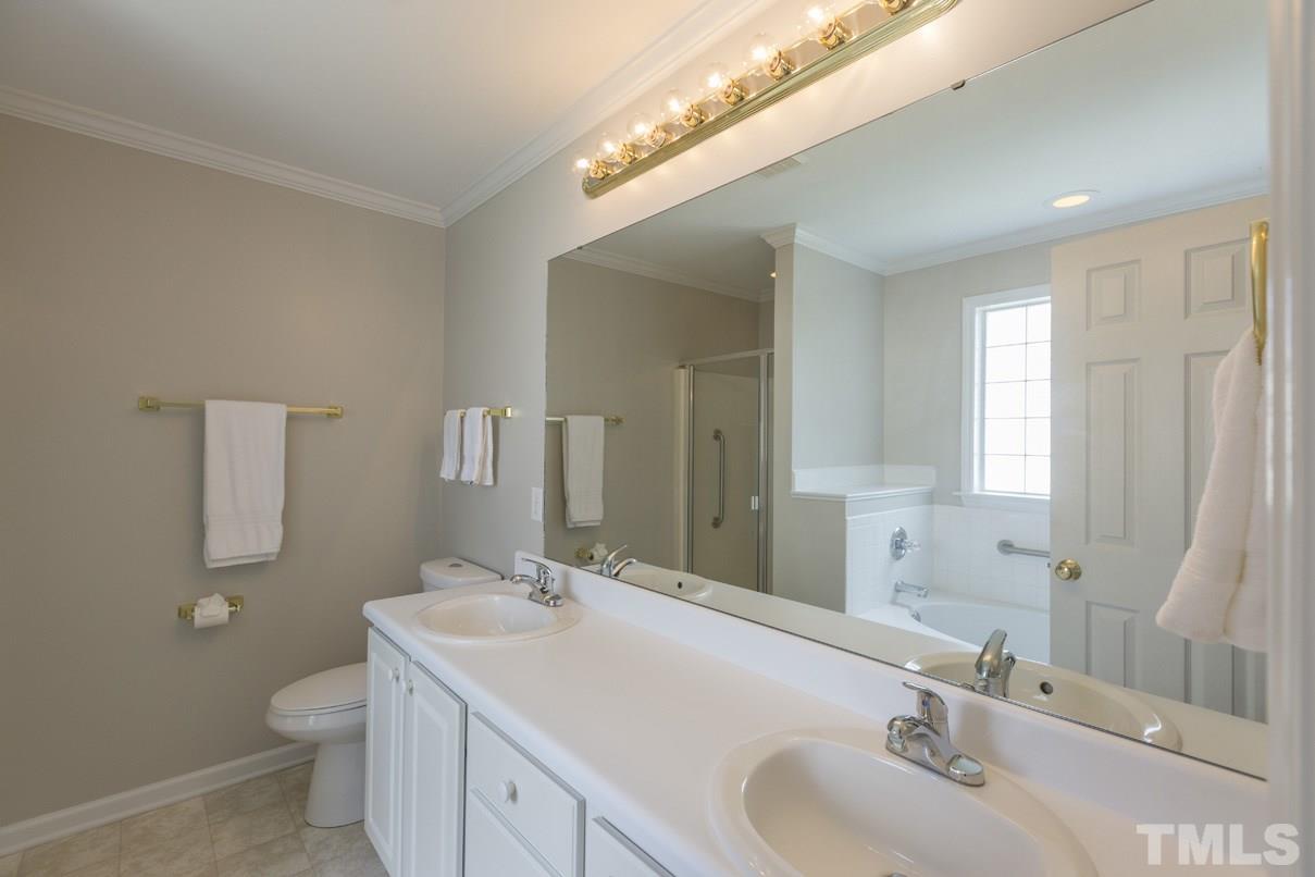 826 Shackleton Road Apex, NC 27502 - Photo 18 of 24 a bathroom with a sink toilet and mirror