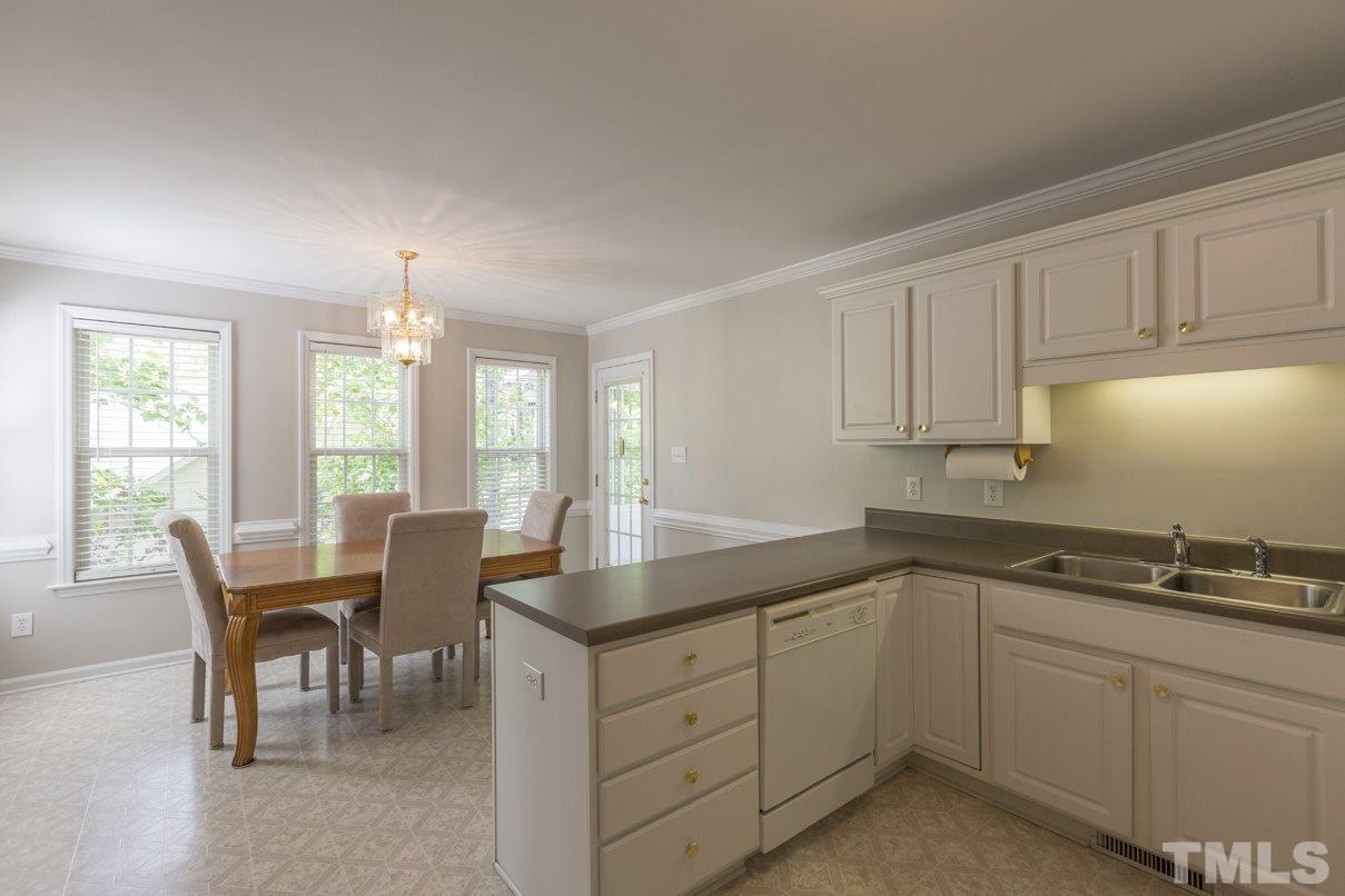 826 Shackleton Road Apex, NC 27502 - Photo 3 of 24 a kitchen with sink and cabinets