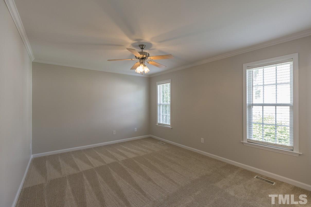 826 Shackleton Road Apex, NC 27502 - Photo 21 of 24 an empty room with windows and fan