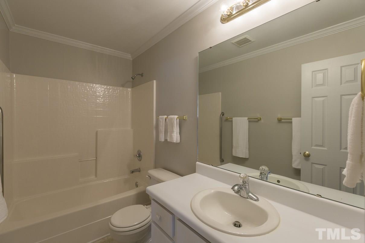 826 Shackleton Road Apex, NC 27502 - Photo 22 of 24 a bathroom with a sink toilet a shower and bathtub