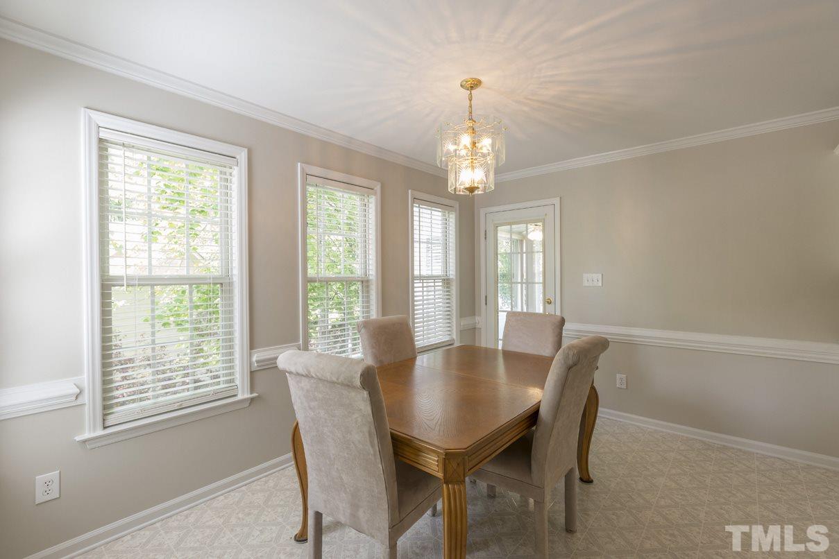 826 Shackleton Road Apex, NC 27502 - Photo 4 of 24 a view of a dining room with furniture wooden floor and chandelier