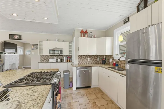 a kitchen with a sink a stove and refrigerator