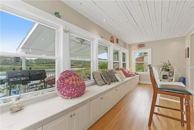 a living room with furniture and large windows