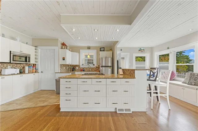 a spacious bedroom with a large bed and wooden floor