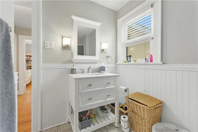 a bathroom with a sink mirror and a toilet