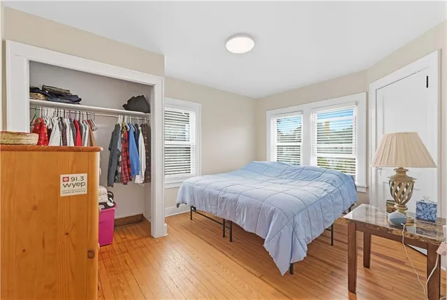 a bedroom with a bed and a large window
