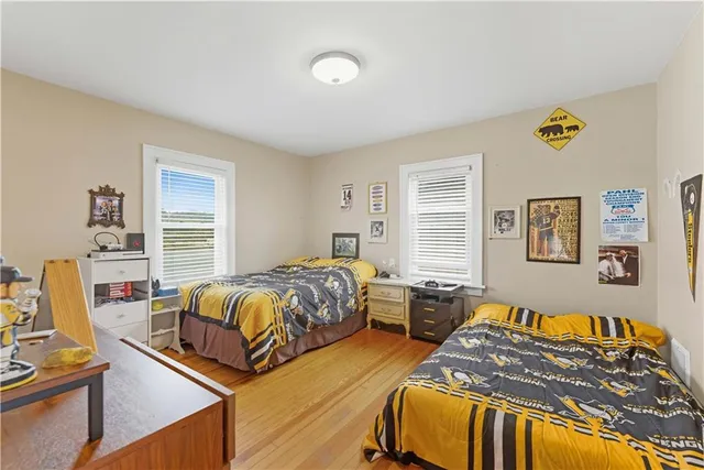 a spacious bedroom with two beds and a window