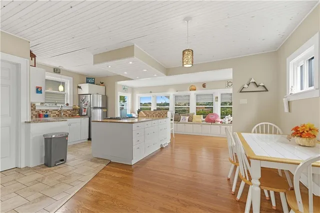 a kitchen with stainless steel appliances kitchen island granite countertop a refrigerator and a stove