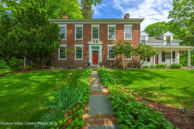 a front view of a house with a yard and porch