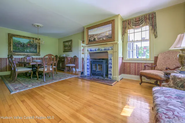 a living room with furniture a fireplace and a table