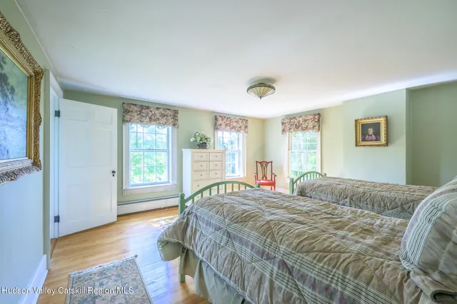 a bathroom with a granite countertop sink a toilet and a shower