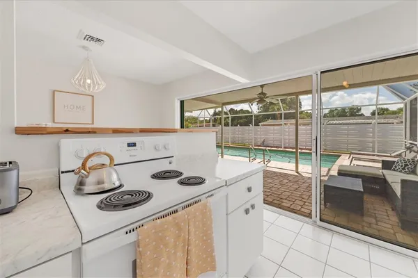a kitchen with white cabinets and sink