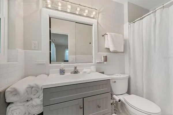 a bedroom with a bed and painting on the wall