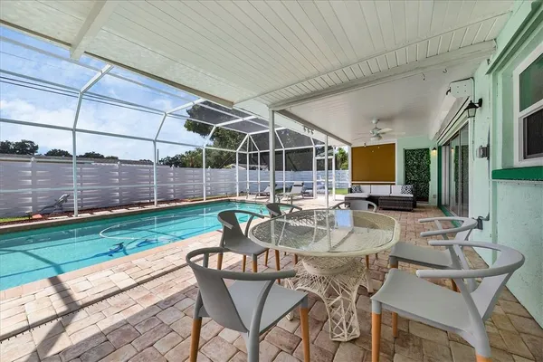 a view of a patio with couches chairs and potted plants