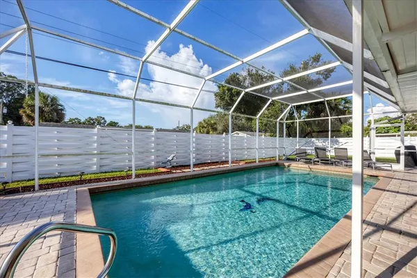 a view of a backyard with swimming pool