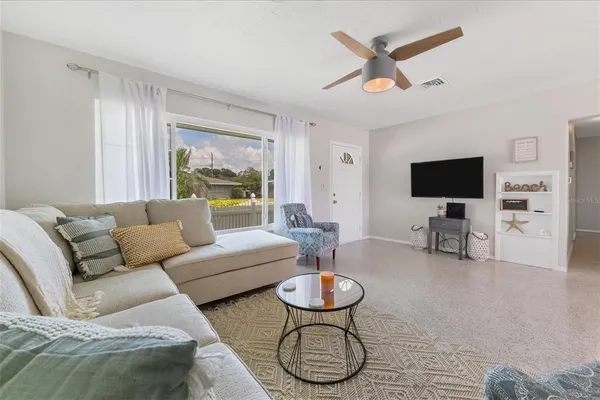a living room with furniture and a large window